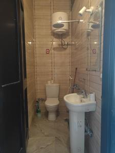 a bathroom with a toilet and a sink at Baywatch Camp in Nuweiba