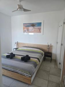 a bedroom with a bed and a painting on the wall at Villa Good Vibes in Ifach +28 photos