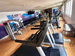 a gym with rows of treadmills and cardio machines at 3ff Megaworld, One Regis in Bacolod