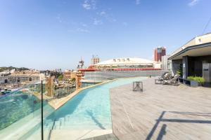 a swimming pool on the roof of a building at B Hotel in Barcelona