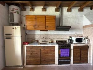 a kitchen with a white refrigerator and a stove at Mab departamento in Colorado River