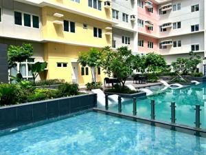 a swimming pool in front of a building at 3ff Megaworld, One Regis in Bacolod +3 photos