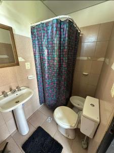 a bathroom with a sink and a toilet and a shower at Mab departamento in Colorado River +15 photos