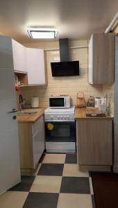 a kitchen with white cabinets and a stove top oven at Гостьовий будинок для відпочинку в Nesterivka Family Park in Boryspil