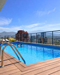 a swimming pool on the roof of a building at LUUM by Norus in Santiago