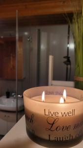 a candle sitting on a table in a bathroom at Ferienwohnungen Blumenschein in Kirchzell +24 photos