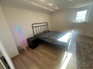 a bedroom with a bed and a wooden floor at Waldsee in Hilgert
