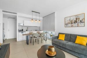 a living room and kitchen with a couch and a table at Redsearent suite with pool view 16 in Eilat