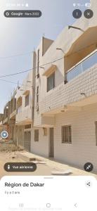 a rendering of a building with the words revision de dakar at studio avec salons séparé et balcon in Dakar