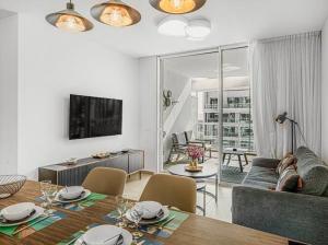 a living room with a dining table and a living room with a couch at Redsearent suite with pool view 16 in Eilat