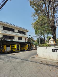three food trucks parked in front of a building at บ้านพักหลังวัดโลกโมฬี in Chiang Mai
