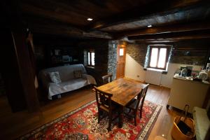 a living room with a table and a couch at Walser House in Rimella
