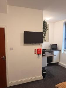an office with a wall with a tv on a wall at Your Cozy Colne Getaway Free parking and views in Colne