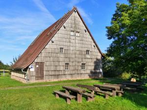 an old barn with benches in front of it at Ferienwohnungen Blumenschein in Kirchzell