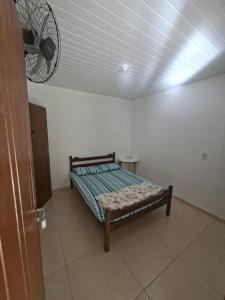 a bedroom with a bed in a room with a fan at Lago Camping Sana in Macaé