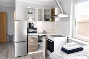 a small kitchen with a refrigerator and a stove at Apartments in Leuna in Leuna +16 photos