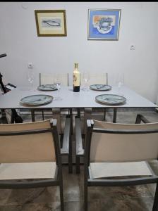 a dining room table with glasses and a bottle of wine at House Vodice in Vodice +14 photos