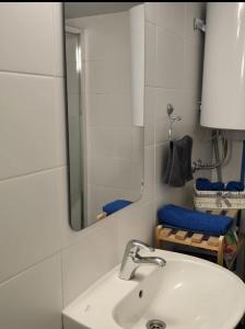 a bathroom with a white sink and a mirror at House Vodice in Vodice