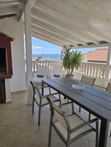 a table and chairs on a patio with a view of the ocean at House Vodice in Vodice