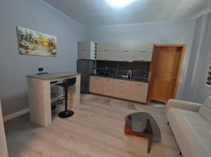 a kitchen with a table and a couch in a room at My Daily Home in Fier