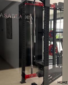 a gym with a weight rack in a room at Homz Maison in Sukrah