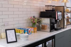 a counter top with food and drinks on it at Best Western Leicester Oadby in Great Glen