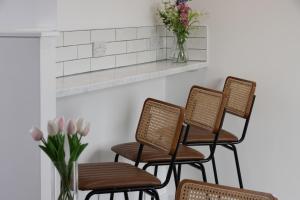 a row of chairs in a waiting room with flowers at Best Western Leicester Oadby in Great Glen