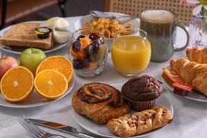 a table topped with plates of breakfast foods and drinks at Best Western Leicester Oadby in Great Glen +17 photos
