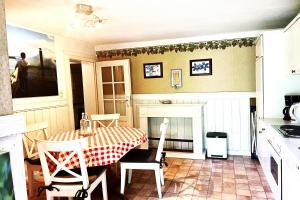 a kitchen with a table and chairs and a fireplace at Ferienhaus-„Alte-Schmiede“ in Westerland