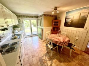 a kitchen with a table and a dining room at Ferienhaus-„Alte-Schmiede“ in Westerland