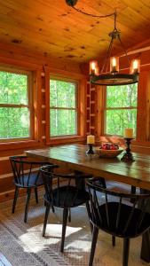 a dining room with a large wooden table and chairs at Hemlock Hill Cabin in Blowing Rock