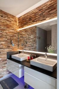 a bathroom with two sinks and a mirror at Harderwold Villa - 372 in Zeewolde +19 photos