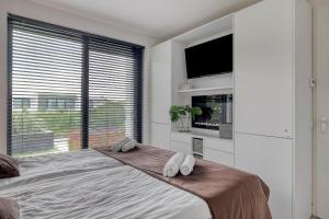 a bedroom with a large bed with two pillows on it at Harderwold Villa - 372 in Zeewolde