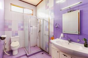 a purple bathroom with a toilet and a sink at Dapur Caringin Tilu Villa in Arcamanik +59 photos