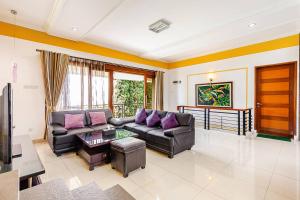 a living room with a couch and a table at Dapur Caringin Tilu Villa in Arcamanik
