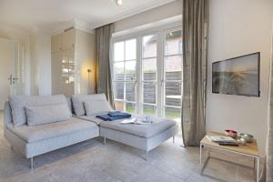 a living room with a couch and a table at Listend Blick in List