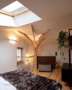 a bedroom with a tree in the ceiling at SKY LOVE Luxury Chalet in Andalo