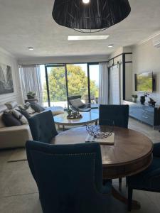 a living room with a table and a couch at Constantia View Apartments- Luxury Self Catering in Cape Town