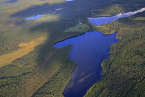 an aerial view of a river in a field at Vanha Väätänen Cottage in Väätänen