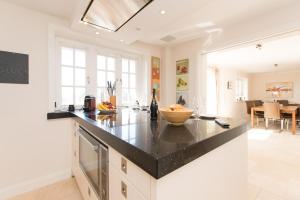 a kitchen with a black counter top in a room at Haus-Meerblick in Rantum