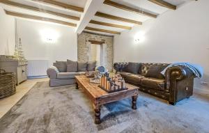 a living room with a leather couch and a table at Luxueuse Maison Avec Piscine in Cravans