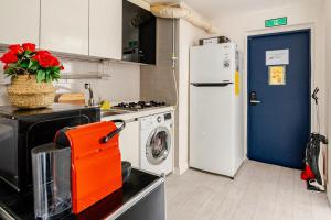 a kitchen with a refrigerator and a washing machine at 코지룸 in Seoul