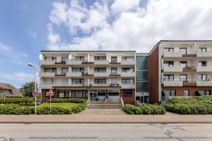 a large building with stairs in front of it at Norderhoog-Whg-45-2-OG-O-Wohnung-45 in Westerland