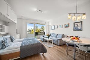 a living room with a couch and a table at Norderhoog-Whg-33-1-OG-O-Wohnung-33 in Westerland