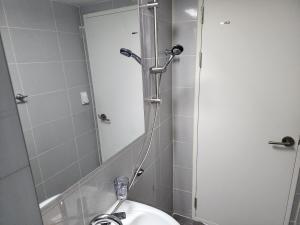a bathroom with a sink and a shower with a mirror at 코지룸 in Seoul +31 photos