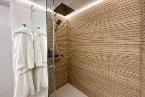 a bathroom with a shower and white towels at Haus-Excelsior-Wohnung-08 in Rantum