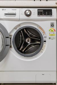 a white washing machine with its door open at 코지룸 in Seoul