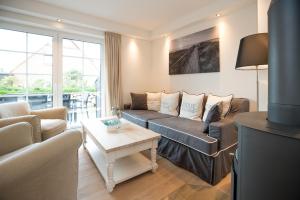 a living room with a couch and a table at Haus-Seestern in Tinnum
