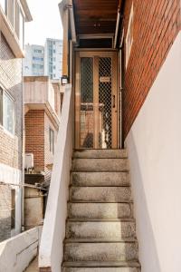 a set of stairs leading to a door on a building at 코지룸 in Seoul