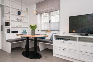 a dining room with a table and a tv at Haus-Friesenperle in Westerland